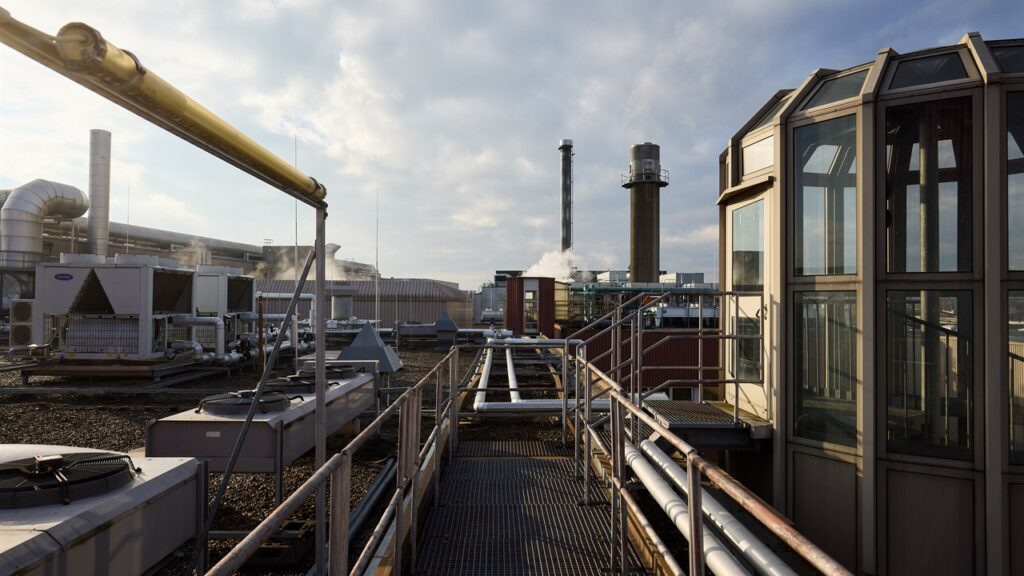 Rooftop walkway at NLND with pipes and the old factory chimneys